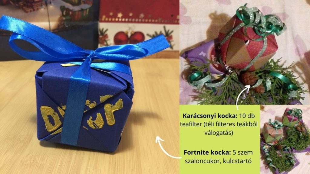 sötétkék papírból hajtogatott Fortnite kocka, benne 5 szem szaloncukor és egy fortnite kulcstartó, bordó-arany papírból hajtott kocka, tujaággal, szalaggal díszítve egy csomag süti tetején, benne 10 darab téli teafilter