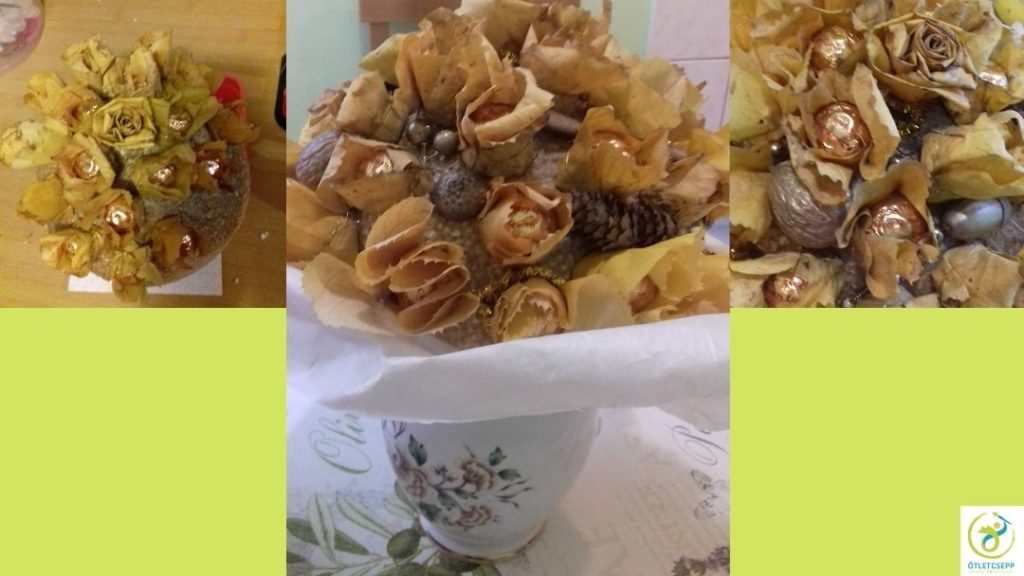 félgömb alakú csokor ferrero rocher bonbonnal, levélrózsákkal, aranyra fújt termésekkel