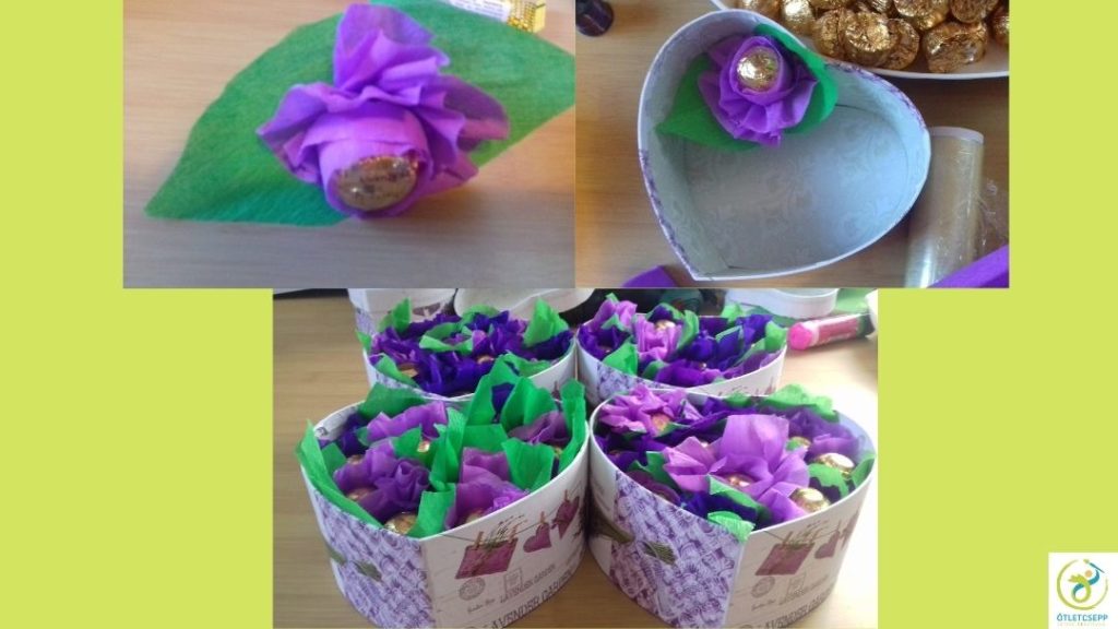 bonbon közepű virágfejek szív alakú dobozba rendezve