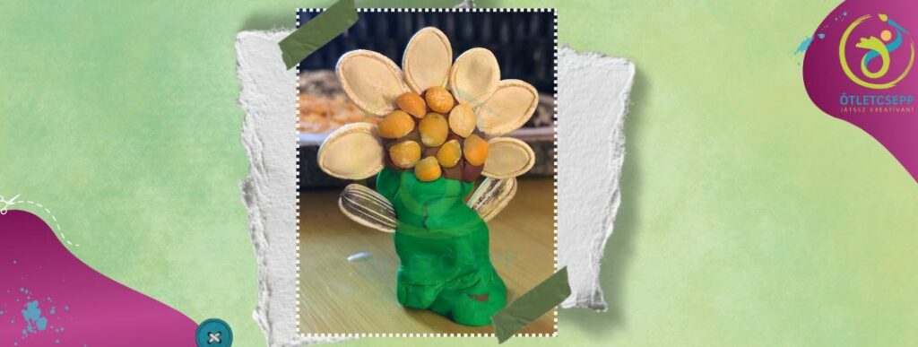 3d virág zöld gyurmaszárral, sárgaborsóval rakott virágközéppel, tökmag virágszirmokkal, napraforgómag levelekkel, 